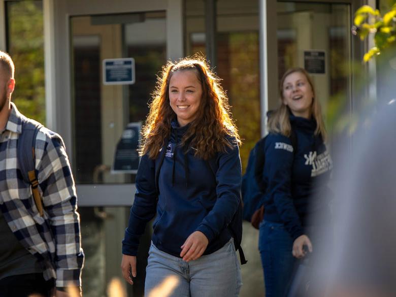 Student smiling walking on campus